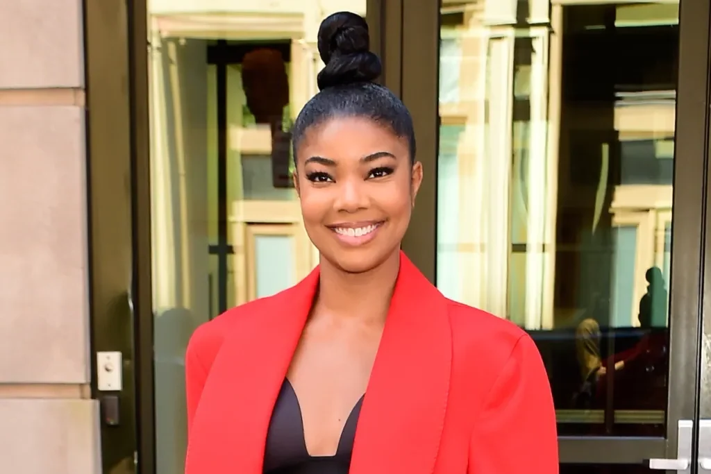 Gabrielle Union does a white pedicure in black strappy sandals while in New York