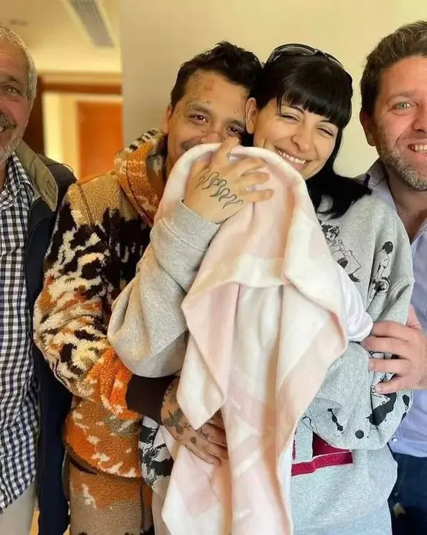Christian Nodal and Cazzu pose with their baby